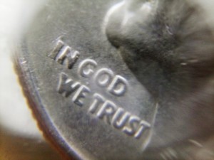 A dime photographed with a phone camera through a water drop